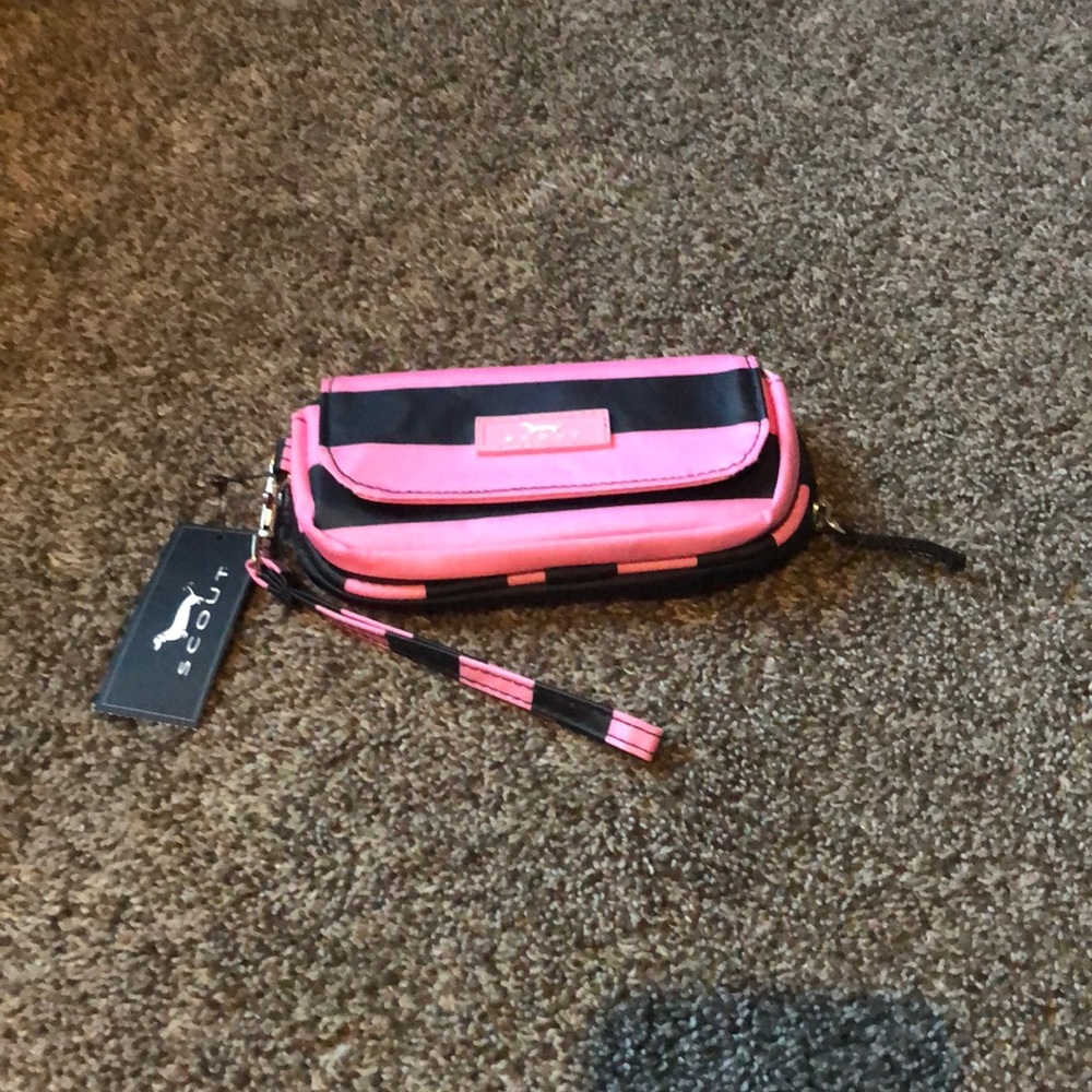 New with tags Scout wallet/wristlet. It is pink and black in color.